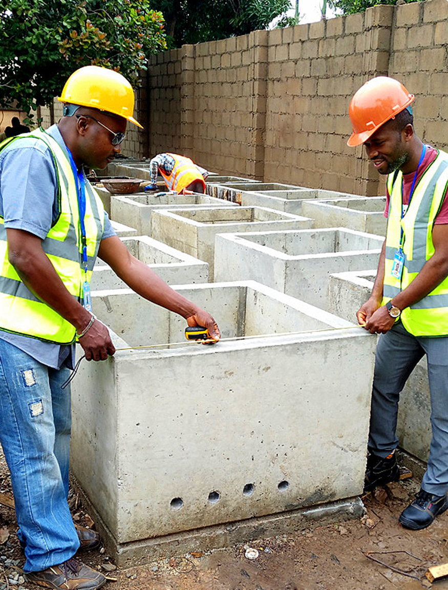 Rich & Ray field engineers measuring concrete handholes